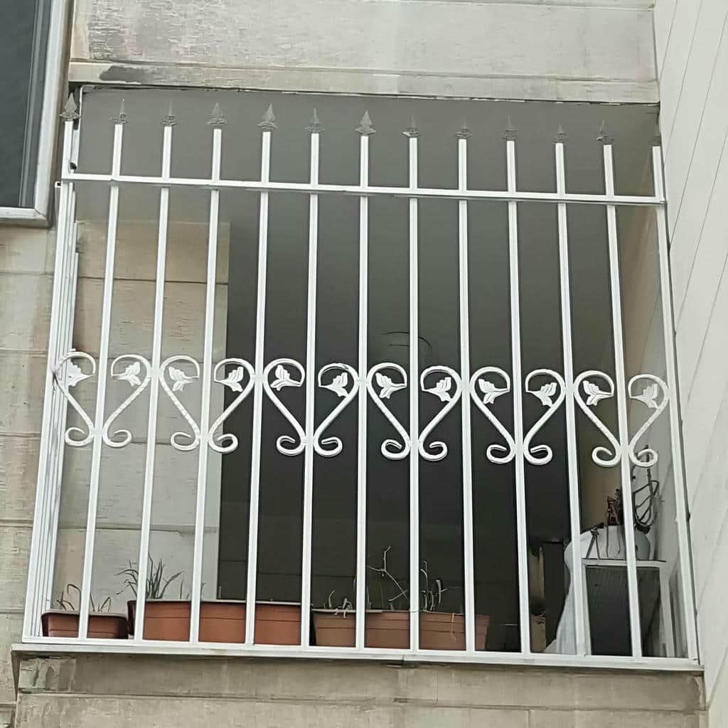 نرده پنجره کلاسیک کنار قاب سنگی روشن